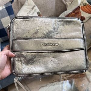 Michael Kors metallic lizard-embossed leather tablet case- a zip closure.
